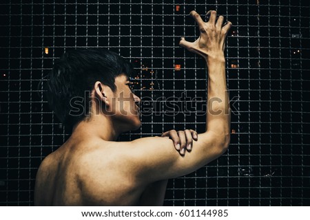 Man imprisoned behind bars 