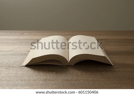 45 degrees with white blank book open with wooden background