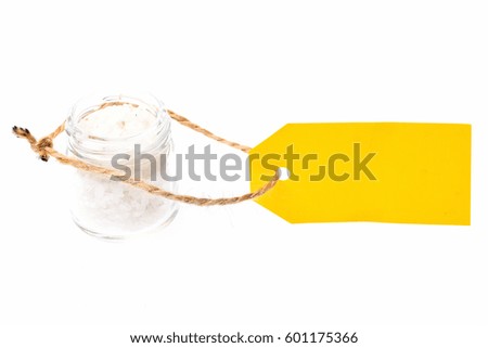 color salt, spice in glass jar with yellow tag isolated on white background, copy space