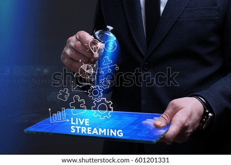 Business, Technology, Internet and network concept. Young businessman working on a virtual screen of the future and sees the inscription: Live streaming
