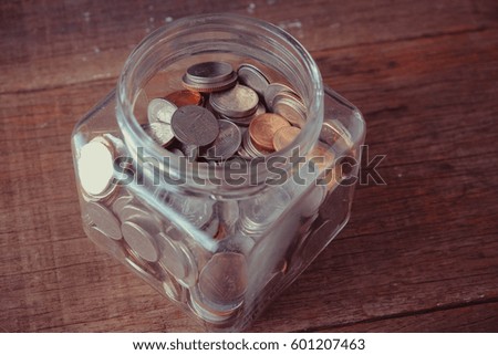 business finance. save money for investment concept money in the glass with filter effect retro vintage style