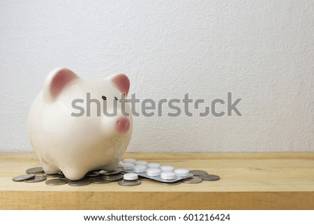 piggy bank with medicine and coins for money concept