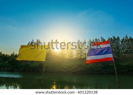 Flag on landscape blue sky at sunset.