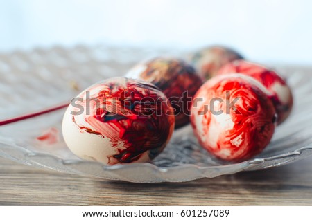 Colorful Easter eggs lying on the plate in red color