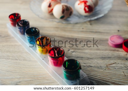 Colorful Easter eggs lying on the plate in red color