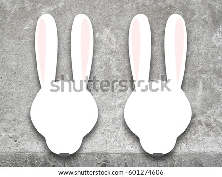 Two hanged blank pink squared rabbit silhouette frames with clips against concrete wall background