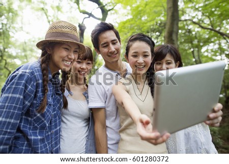 Group of friends at an outdoor party in a forest