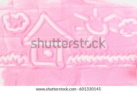 Painted house of decorative sand on a wooden table. Children's drawing of colored decorative sand of the sea.