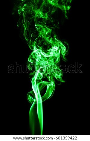 Green colored smoke on a black background.