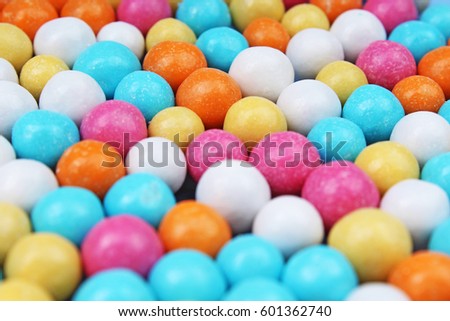 Shiny sugar coated round chocolate balls as background. Candy bonbons multicolored texture. Round candies sweets pattern concept. Food photo studio photography. Candy background