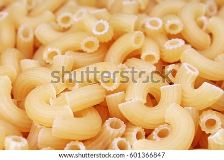 Macaroni dry pasta background concept. Pasta texture for background uses. Swirled pasta pattern. Food photography in studio.

