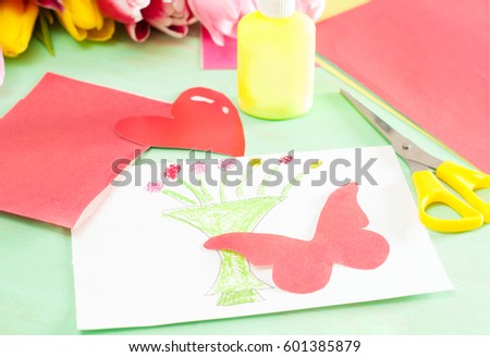 Homemade card with butterfly on the wooden background