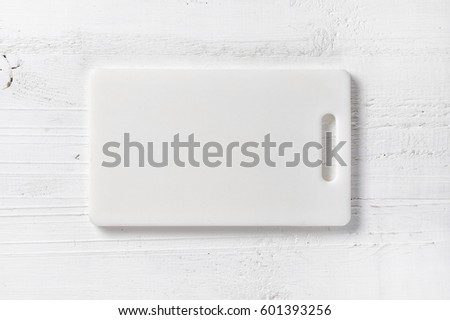 white plastic cutting board on table, top view Royalty-Free Stock Photo #601393256