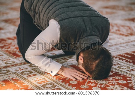 Muslim man prostrating on the ground of the Mosque