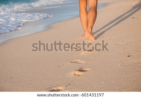 Feet walking along the coast