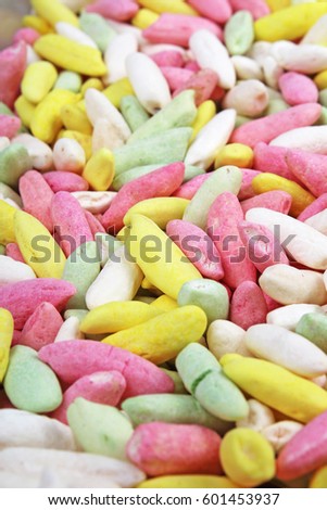 
Candy from puffed rice grains. Sweet flavored puffed rice grains. Colorful snack.
