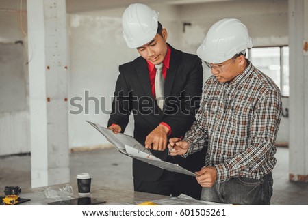 Management consulting with engineers working with blueprint and drawing on work table in for management business plan and construction site project.