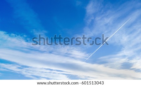 The blue skies with plane trails in a sunny day