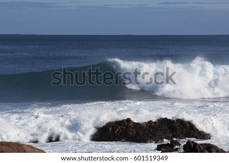 Huge  waves of the Indian Ocean  rolling in at famous Yallingup Beach,South Western Australia a world famous surfing mecca, on a cold yet sunny winter morning.