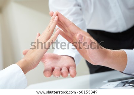 Image of business people palms opposite each other symbolizing support and unity