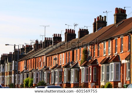 English row terrace house in spring season, England UK. Brick building in the town. Royalty-Free Stock Photo #601569755