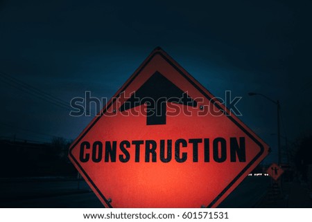 construction sign outdoors on dark background