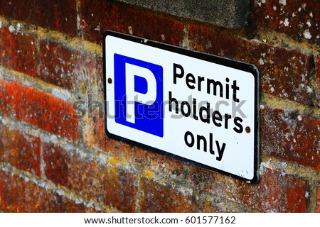 Permit holders Car Parking sign against brick wall, England UK.