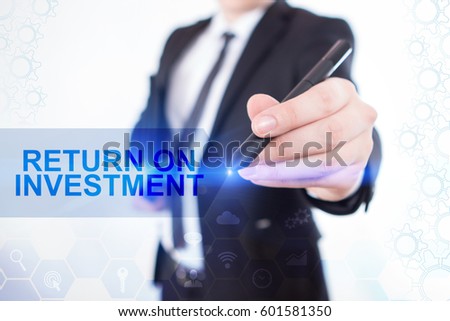 Businessman Write On The Virtual Screen Return On Investment. Close Up Hand With A Pen. Touch Screen. Virtual Icon. Graphs Interface. Business concept. Internet concept. Digital Interfaces