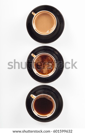 Three cups of coffee with black, white and flowing milk on white background