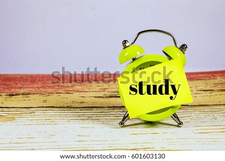  Conceptual image of Business Concept with words " study" on at clock with a wooden desk background. Selective focus.