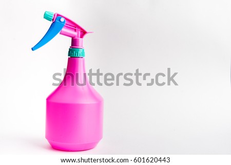 Small liquid atomizer of different colors on a white background, sprayer
