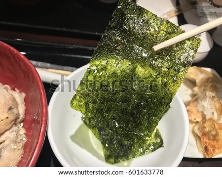clamp green sheet seaweed in a bowl white Japanese food