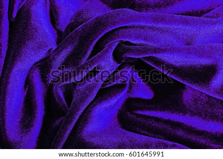 Purple blue Velvet dress material cloth texture pattern. 
tailoring stitching concept. Shiny beautiful fashion fabric. Shiny clothing material sample.Creased fabric.