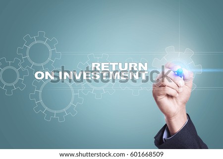 Businessman drawing on virtual screen. return on investment concept.