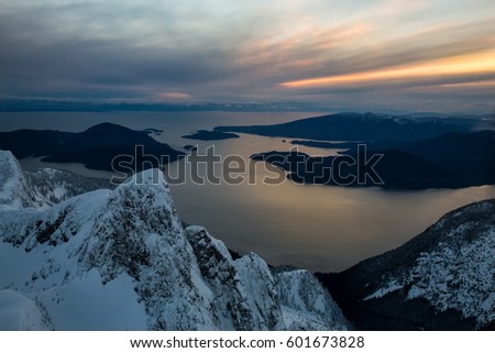 Beautiful aerial landscape of Howe Sound during a cloudy winter sunset. Picture taken north of Vancouver, British Columbia, Canada.