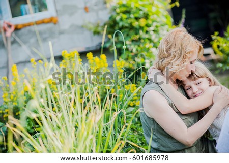 Happy loving family. Mother and daughter on the street embracing