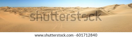 Big sand dunes panorama. Desert or beach sand textured background. Royalty-Free Stock Photo #601712840