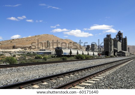 Railroad cars line up to be loaded at California cement manufacturing plant