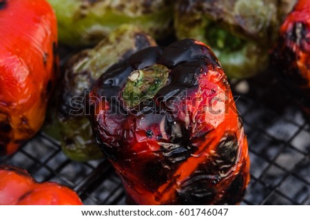 The process of cooking vegetables in the grill grate. Baking paprika, mushrooms and zucchini. 