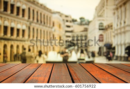 blurred image wood table and people crowd walking on busy street