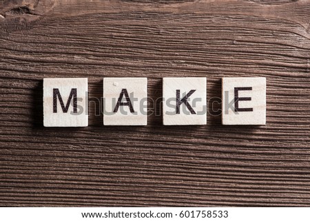 Make it real phrase collected of wooden elements with the letters