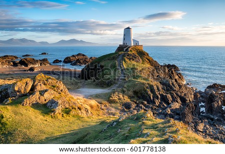 The lighthouse on Llanddwyn Island near Newborough on the Anglesey coast in Wales Royalty-Free Stock Photo #601778138