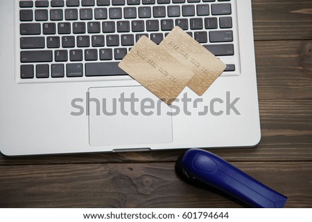 Credit card on laptop and stapler