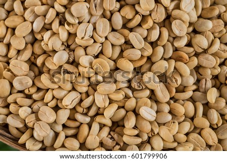 Arabica coffee beans on table background texture.