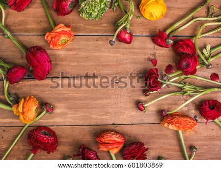 Ranunkulyus bouquet of red flowers on a wooden background