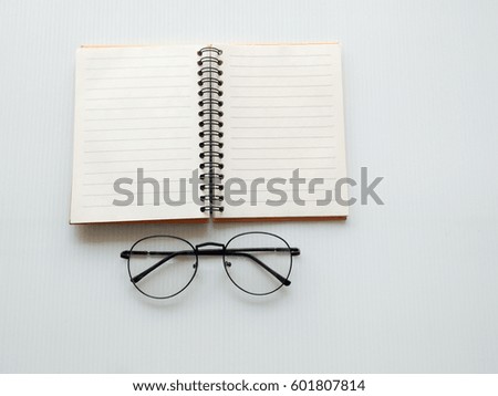 Diary for note and glass on white background