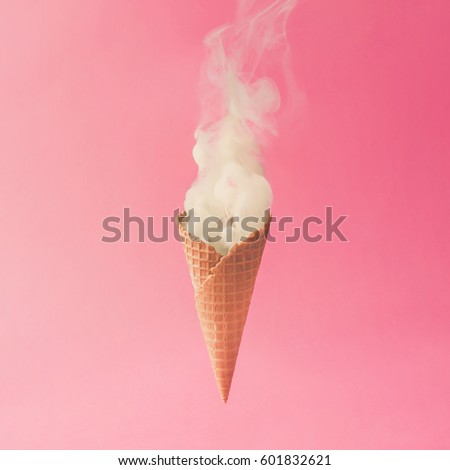 Ice cream cone and white smoke on pastel pink background. Flat lay. Minimal summer concept.