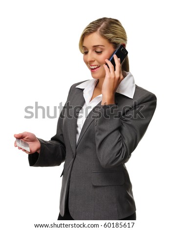 Attractive woman holds credit card and talks on phone