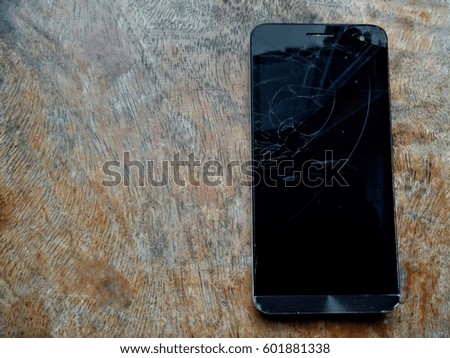 broken mobile phone on the wood