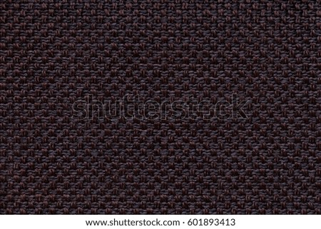 Dark brown and black background with checkered pattern, closeup. Structure of the fabric macro.